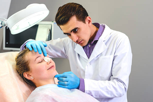 Doctor is checking patient's nose after a nose job